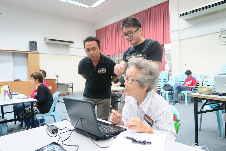Facilitators guide one of the participants during the workshop.